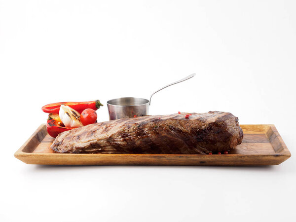 Restaurant dish. A piece of beef and vegetables cooked on the grill.