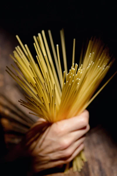 Hand with Italian spaghetti — Stock Photo, Image