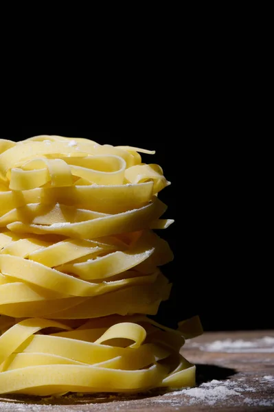 Closeup Raw Tagliatelle Pasta Black Background — Stock Photo, Image