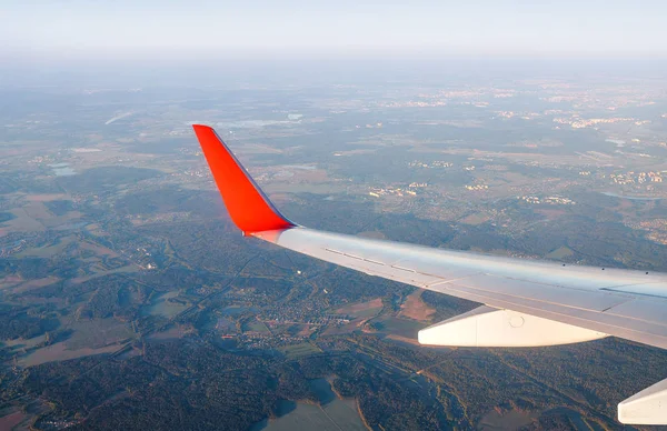 View from a landing airplane out the window on a city suburbans