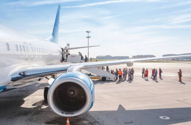 11 MAY 2018, MOSCOW, RUSSIA, VNUKOVO AIRPORT: Passengers on the ladder boarding the airplane of the lowcost airline Pobeda clipart