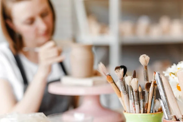 Woman Artist Working Apron Smiles Paints Clay Pottery Brushes Other — Stock Photo, Image