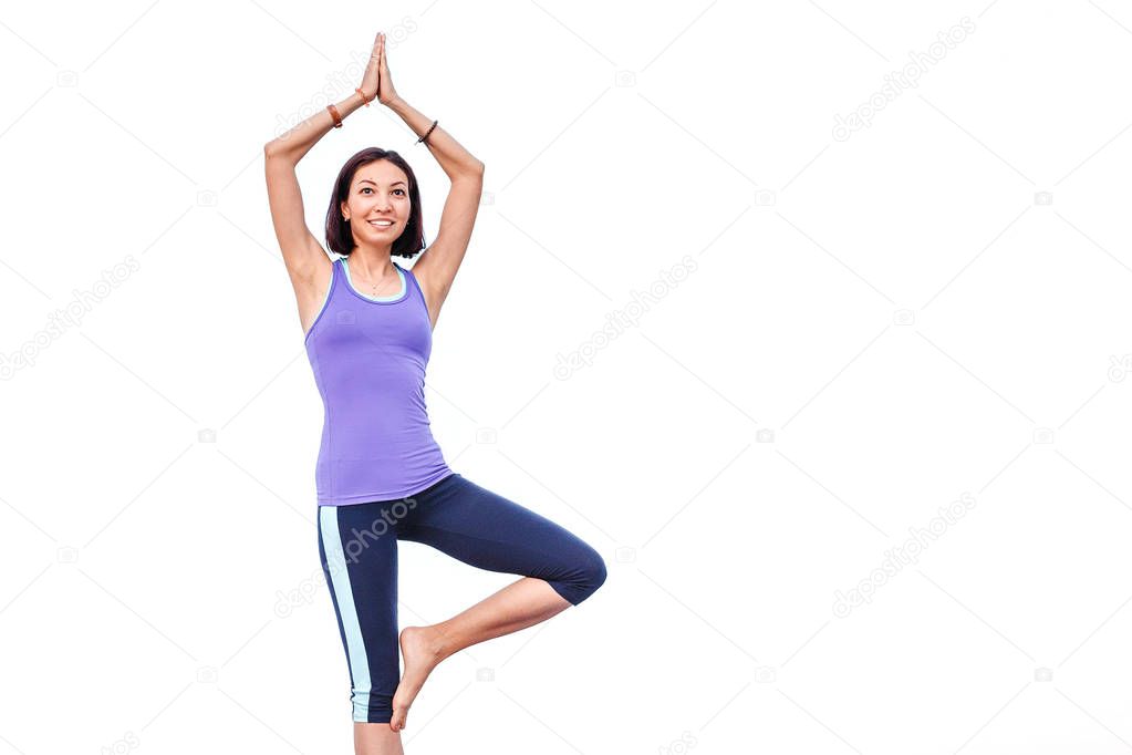Woman doing yoga standing asana isolated on white