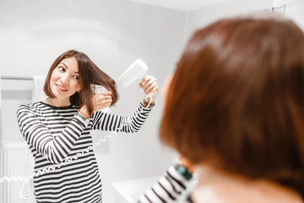 Young Happy Woman Smiling Drying Her Hair Hairdryer Mirror Bathroom — Stock Photo, Image