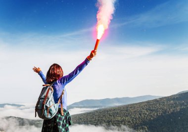 Bir kadın ormanda yürüyüş sırasında acil durum kavramı bir imdat sinyali hangi bir parlak alev ve Turuncu dumanın, gelir Falsch feuer meşale kullanarak Sos vahşi dağlar verir