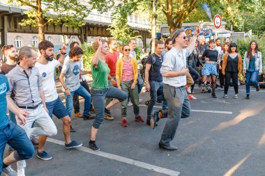 BERLIN, GERMANY - 20 MAY 2018: dance flash mob at the Festival of Cultures in Berlin. People dancing lindy hop outdoors at city street clipart