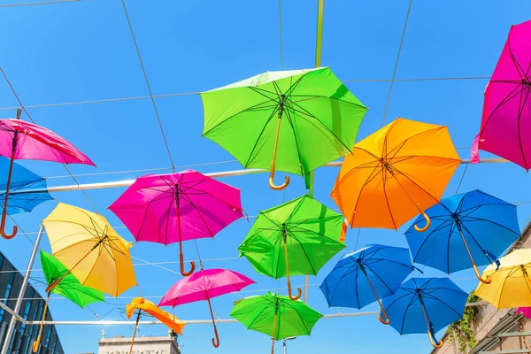 Multicolored umbrellas hanging in the outdoor cafe