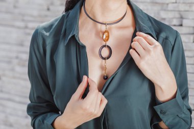 yakın çekim portre şık el yapımı takı kolye giyen güzel bir kadın. Moda aksesuarları kavramı