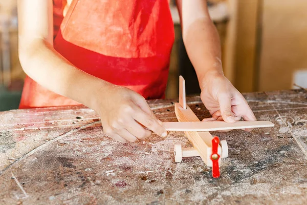 Little Boy Hand Works Creating Wooden Airplane Toy Carpentry Woodwork — Stock Photo, Image