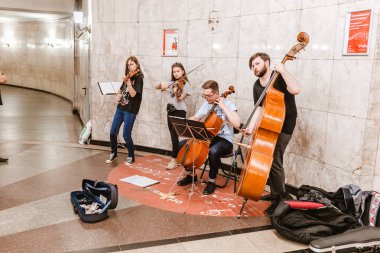 08 JULY 2018, MOSCOW, RUSSIA: Band plays jazz in subway clipart
