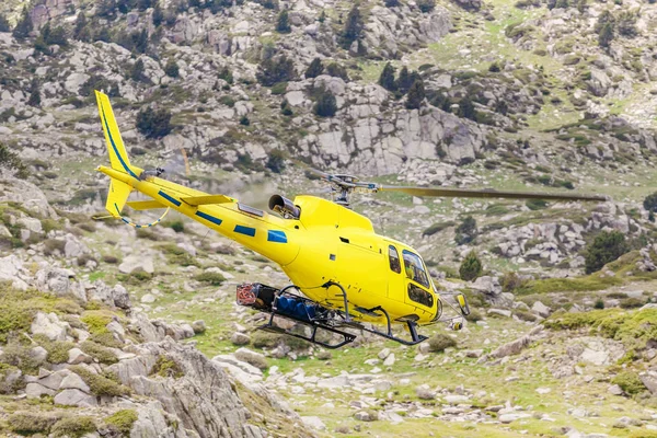Helicopter flight over Pyrenees Mountain valley, emergency and transport concept