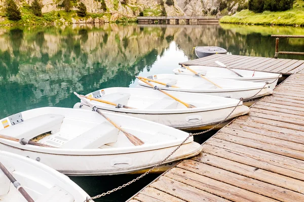Boat rental for tourists on a mountain lake in the valley of Nuria, Spain. Pyrenees ridge.