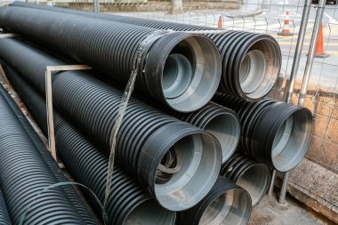 Stacks of water pipes, repair and construction concept clipart