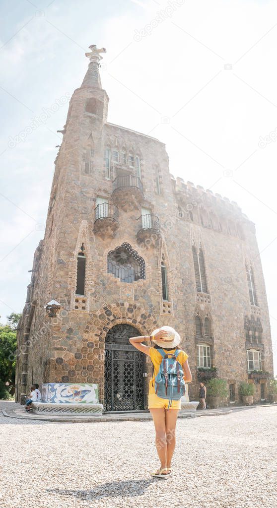 Tourist traveler woman enjoying view of the Bellesguard tower architecture in Barcelona