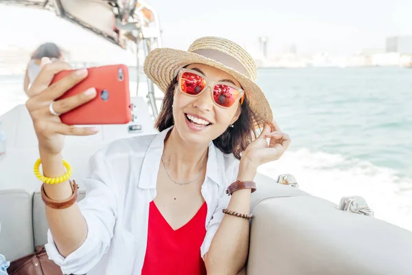 Asian happy tourist Woman taking selfie portrait during her Cruise on a ship