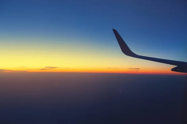 Wing of an airplane at evening or night time