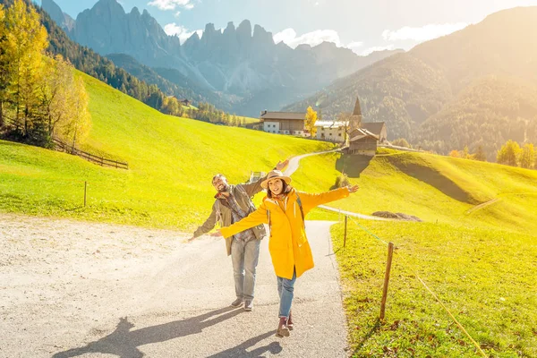 Active three friends travel during autumn holiday and vacation in the mountains of the Dolomites in the Bolzano region in Italy