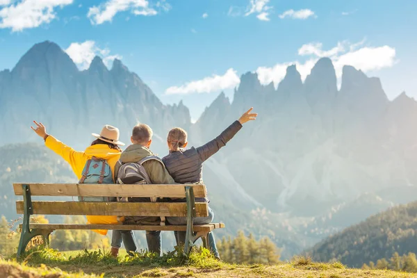 Active three friends travel during autumn holiday and vacation in the mountains of the Dolomites in the Bolzano region in Italy