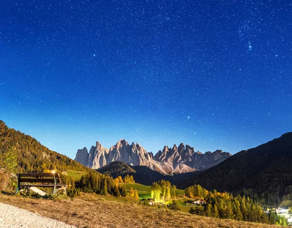 Funes valley in Dolomites mountains at night. Stars and moonlight over Odle mountain range