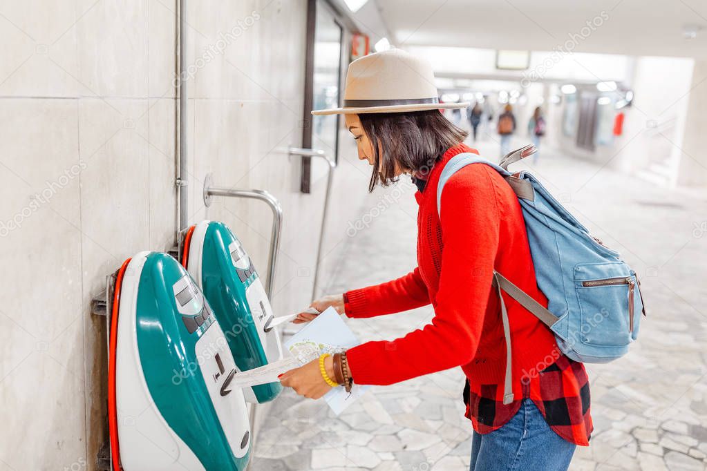 Woman validating ticket on modern public train transport