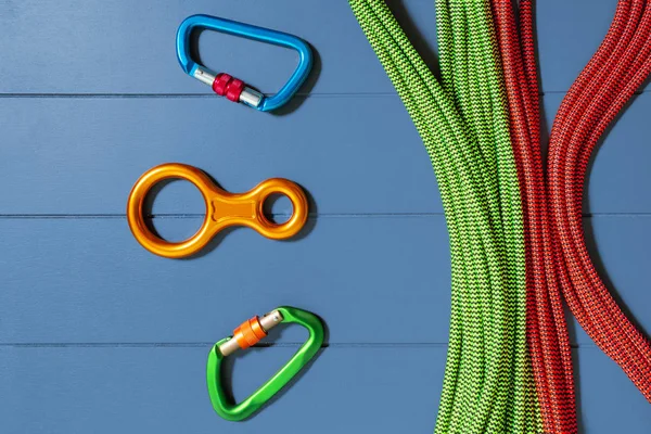 Snap hooks and a coil of rope top flat lay view, the concept of climbing equipment and adventure