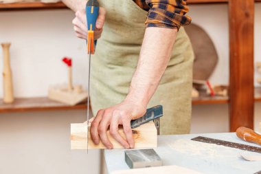 Testere ile bir inşaatta çalışan marangoz. emek Emanet 