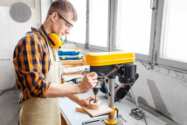 Professional craftsman working on drilling machine in the factor — Stock Photo, Image
