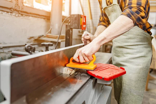 Male craftsman working with automated saw machine in factory or — Stock Photo, Image