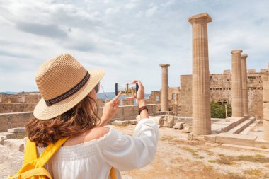 Turist kız fotoğraf ve antik Akropolis kentin turistik dönüm noktası selfie çekiyor. Seyahat destinasyonları ve gezi turları
