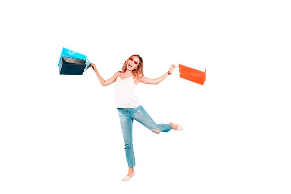 Full length portrait of jumping happy asian woman with shopping bags — Stock Photo, Image