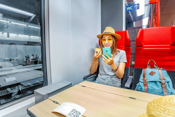 Ασιατικές ευτυχισμένη γυναίκα χρησιμοποιώντας smartphone μέσα πολύ μακρινό τρένο. Ιδέα για σιδηροδρομικές μετακινήσεις και σύνδεση στο διαδίκτυο — Φωτογραφία Αρχείου