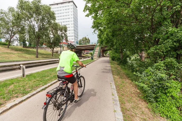 19 July 2019, Vienna, Austria: Man riding a bicycle at the lane in big city — Stock Photo, Image