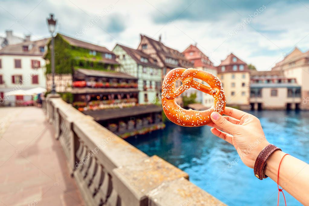 delicious pretzel at the background of Strasbourg city landscape