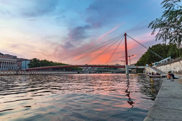 23 de julio de 2019, Lyon, Francia: Paisaje urbano de Lyon al atardecer con pasarela roja que conduce al Palacio de Justicia sobre el río Saone — Foto de Stock