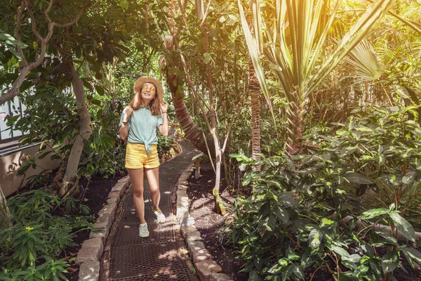 Cestička mladá ženy procházka v botanické zahradě — Stock fotografie