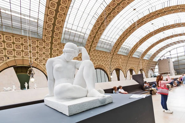 27 July 2019, Paris, France: woman looking at ancient sculpture in showroom hall in Orsay museum. Critic and aesthete concept — Stock Photo, Image