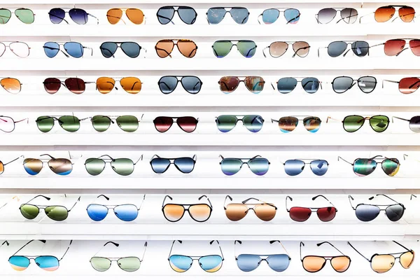 Police s velkým počtem barevných a módních slunečních brýlí na displeji — Stock fotografie