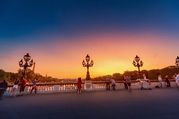 28 juli 2019, Paris, Frankrike: folk går på Alexander III-bron under en ljus solnedgång över Seine. Resa till Paris — Stockfoto