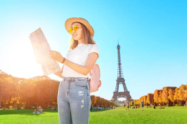Mujer asiática feliz leyendo el mapa delante del famoso hito de París - Torre Eiffel. Turismo en Francia — Foto de Stock