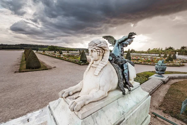 Ancient white sphinx statue in royal garden of Versailles