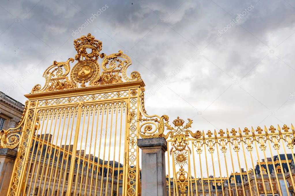 golden gates of the main entrance to the Royal Palace of Versailles, the main residence of Louis. Tourist and historical attractions of France