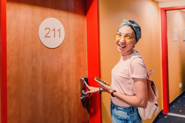 Mujer asiática entrando en la habitación de hotel usando el código de almohadilla en la puerta — Foto de Stock
