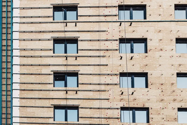 Installation of insulation on the exterior facade of a multi-storey residential building