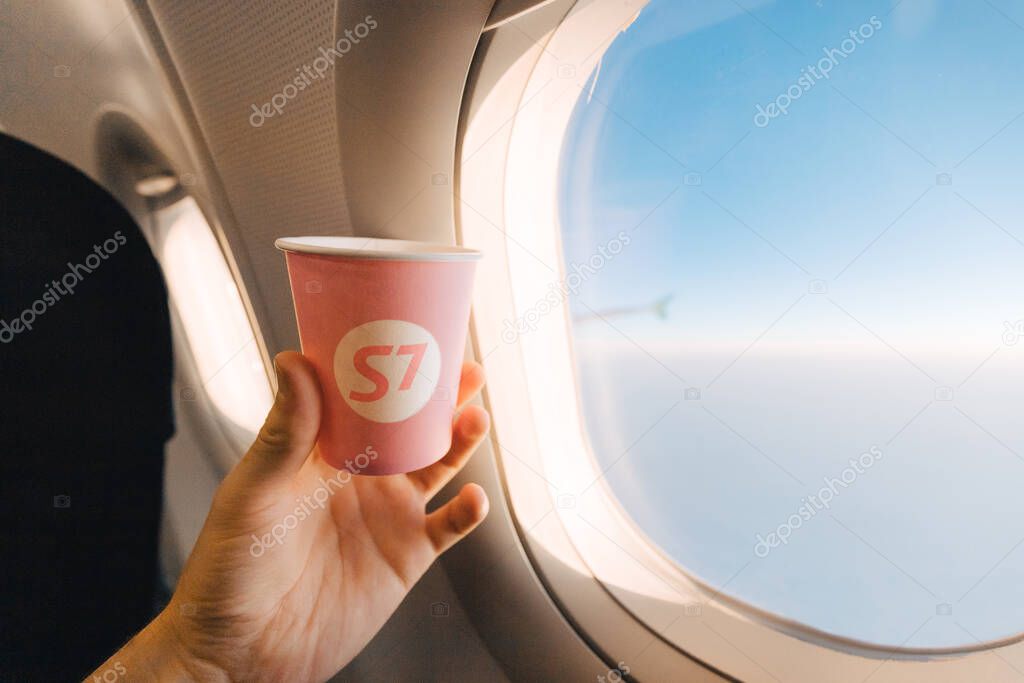 02 September 2020, Moscow, Russia: Paper Cup with the S7 airline logo on the plane during the flight