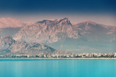 Panoramic idyllic view of the sea coast in Antalya. Taurus mountains in the background and the blue Bay of the Mediterranean sea clipart