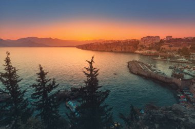 Antalya şehrinin gözlem güvertesinden gün batımının muhteşem manzarası. Birçok yat için Marina ve Park yeri olan sessiz bir körfez.