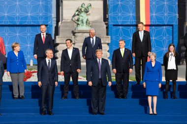 BRUSSELS, BELGIUM - Jul 11, 2018: Jens Stoltenberg, Donald Trump, Angela Merkel and Teresa May at the group photo of participants of the NATO military alliance summit clipart