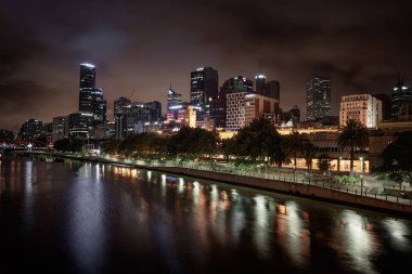 Melbourne, Avustralya - 11 Aralık 2014: Melbourne silüeti alacakaranlıkta Yarra Nehri boyunca. Başkenti ve en kalabalık şehri Victoria eyaletinde ve ikinci en kalabalık şehir Avustralya Melbourne olduğunu