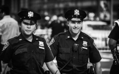 NEW YORK, USA - Sep 21, 2017: Police officers performing his duties on the streets of Manhattan. New York City Police Department (NYPD) is the largest municipal police force in the United States clipart