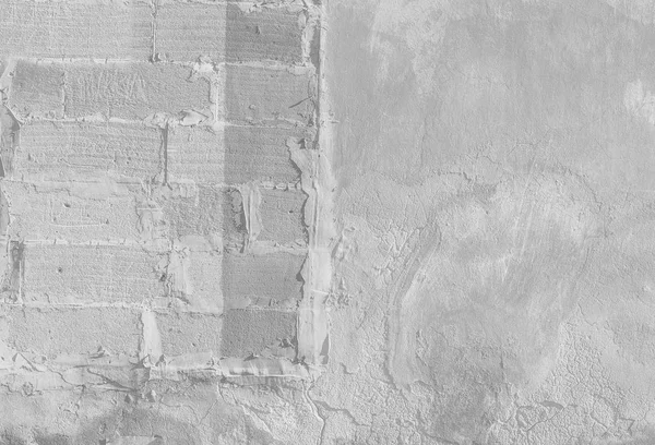 Abstract light gray background. Vintage bricklaying structure. Uneven painted plaster in whiten facade background.